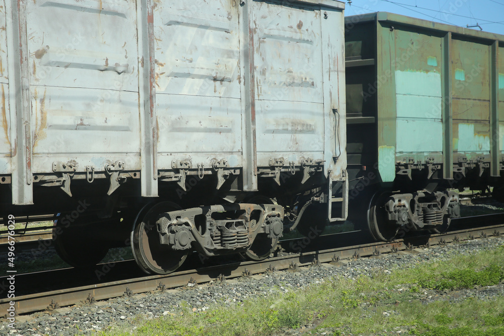 view from the train window of the railway station, freight train cars and the railway view from the train window of the railway station, freight train cars and the railway