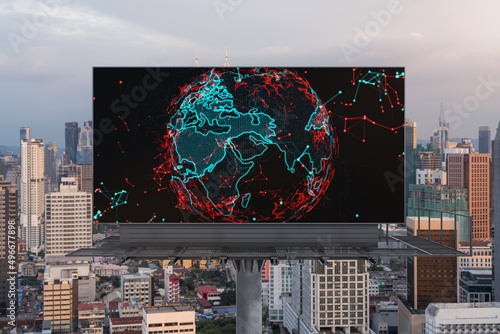 Glowing hologram of Earth planet map on billboard over aerial panoramic cityscape of Kuala Lumpur at sunset, Malaysia, Asia. The concept of international business in KL.