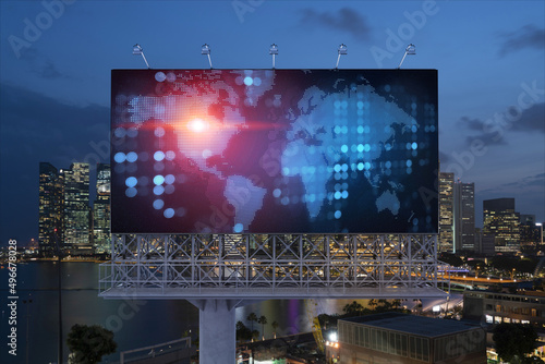 Hologram of Earth planet map on billboard over night panoramic cityscape of Singapore. The concept of international companies in Southeast Asia. Globe