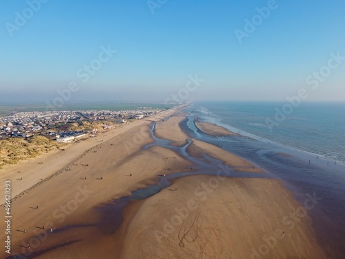 Aerial drone. Camber Sands in East Sussex. Popular seaside destination with large sandy beach and surfing spot in England. photo