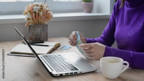 Wallpaper Mural Close-up of female hands, counting money, salary, income, savings, money, euro on the background of a laptop. Family budget concept Torontodigital.ca