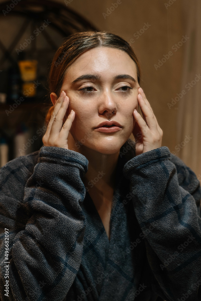 Girl touching her face with two hands Girl touching her face with two hands