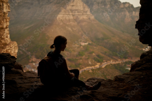 Taking the rugged route to paradise. Shot of a woman admiring the view from a mountain top.