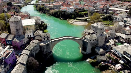 Old Bridge and Neretva river in Mostar, Bosnia and Herzegovina. Aerial drone view of Old town Mostar in spring. photo