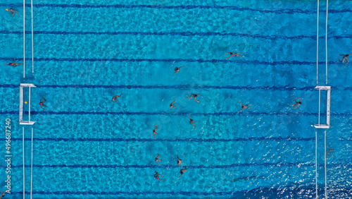 Aerial drone top down photo of water polo tournament as seen in huge pool