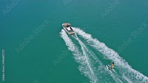 Aerial photo of extreme power boat water-sports cruising in high speed in tropical emerald bay © aerial-drone