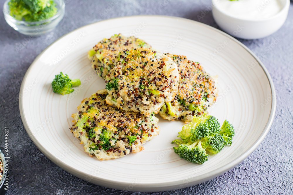 Fried quinoa and broccoli mix pancakes on a plate. Close-up