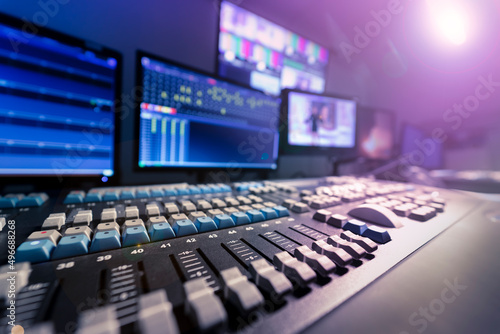 Lighting control in television studio. Lighting engineering table. Dimmer light. Monitor. 