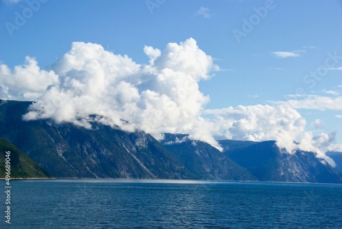 Mountains and blue sky with clouds in summer in Sognefjorden in Sogn og Fjordane fylke in Norway.