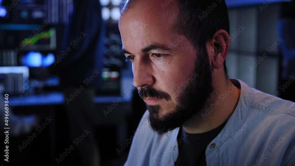 Team of stockbrokers are having a conversation in a dark office with display screens. Professional IT Technical Support Specialist Working on Computer Monitoring Server Data, Blockchain Network