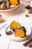Pumpkin bundt cake with chocolate glaze and nuts on top, top view