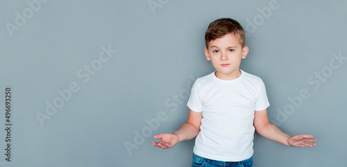 Photography Closeup portrait of dumb clueless confused boy, arms out asking what's the problem who cares so what, I don't know
