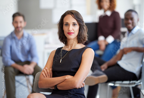 I have their support. Portrait of an attractive businesswoman with coworkers in the background.