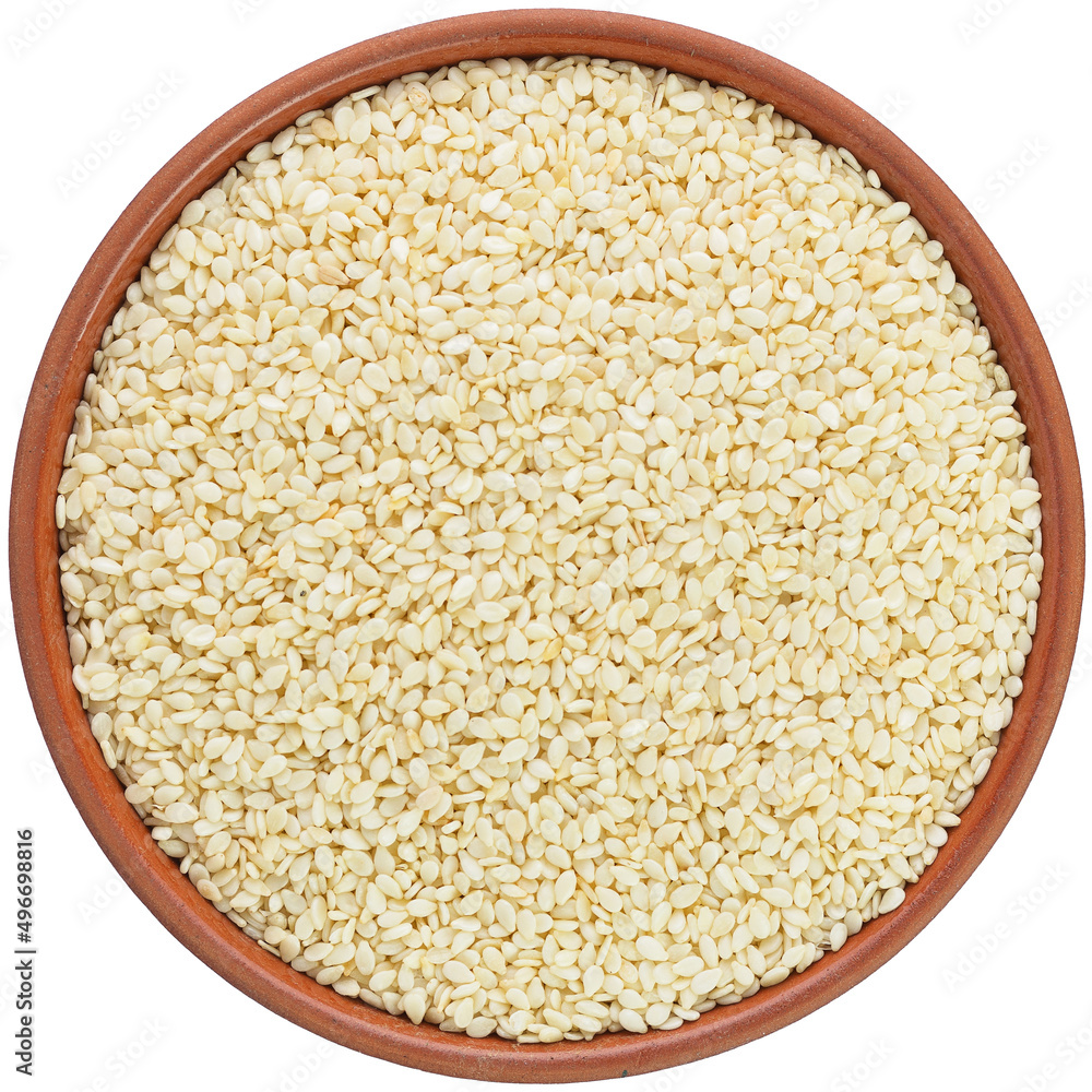 White Sesame seed in a brown ceramic bowl. Isolated close-up photo of food close up from above on white background. White Sesame seed in a brown ceramic bowl. Isolated close-up photo of food close up from above on white background.