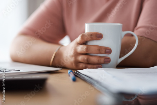 Coffee helps my brain function. Cropped shot of a woman working from home.