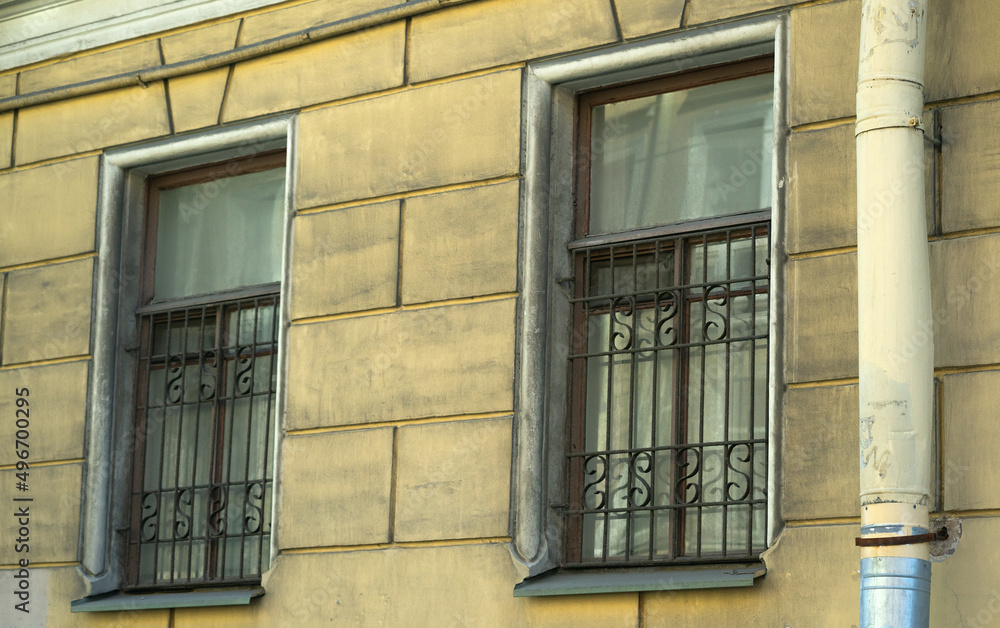 The windows in the old house are closed with metal bars.  To protect your home from thieves.