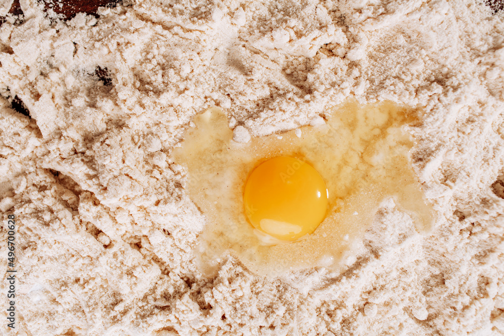 Baking background with cake ingredients on wood from above bowl flour eggs
