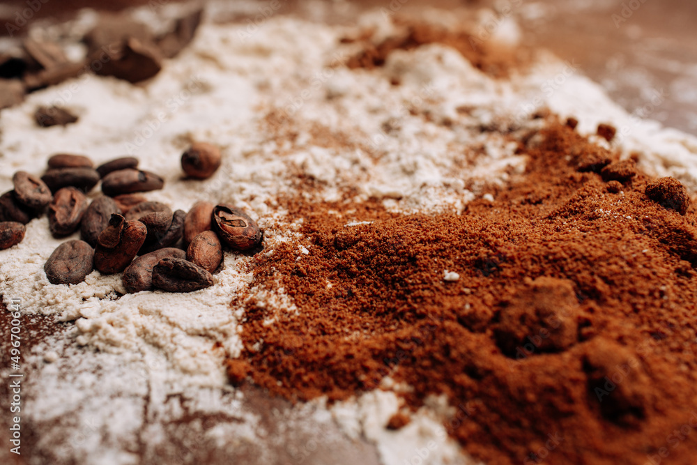 Baking background with ingredients for cake on wood with flour and cocoa Baking background with ingredients for cake on wood with flour and cocoa