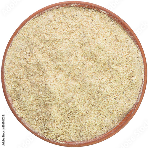 Obraz na płótnie Ground cardamom in a brown ceramic bowl isolated on white background