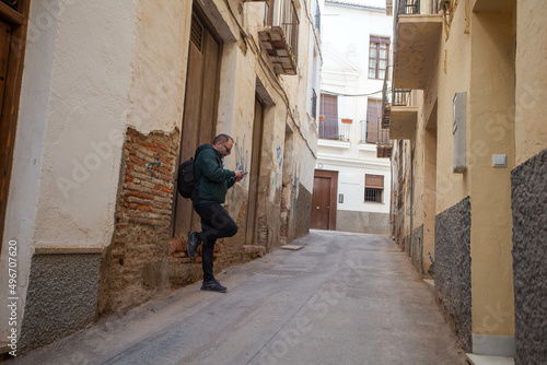 boy checking his mobile phone on the streets of cuenca