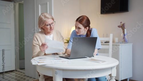 Daughter helps her elderly mother pay bills online