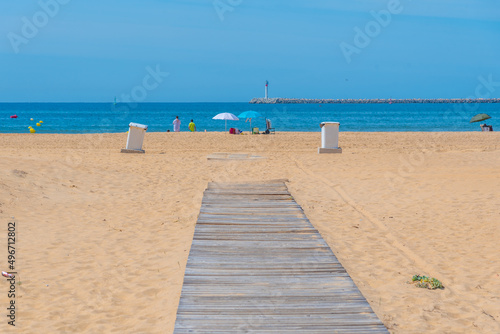 People are enjoying a sunny day on a Mazagon beach near Huelva, Spain. photo
