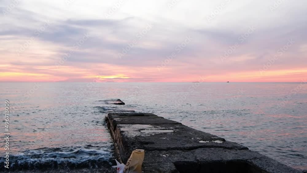 Fishing pier on the ocean with a colorful and golden sunset. Ocean beach sunrise and dramatic colorful sky clouds. Fishing pier on the ocean with a colorful and golden sunset. Ocean beach sunrise and dramatic colorful sky clouds.