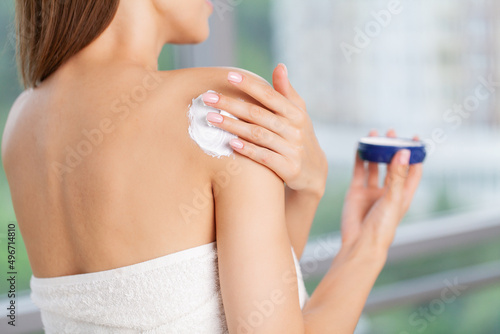 Beauty woman with moisturizer concept in the bathroom