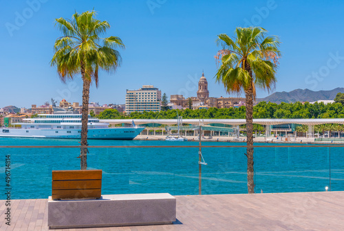 Big yacht with the cathedral in background in Malaga, Spain. photo