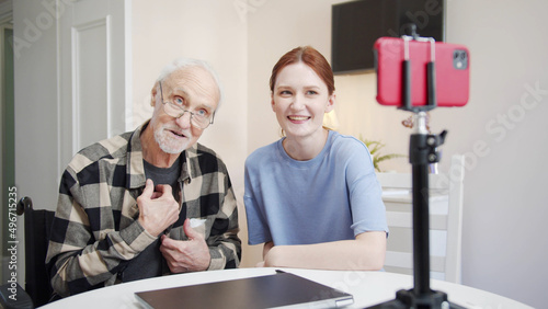 A girl interviews an elderly man with glasses on stream