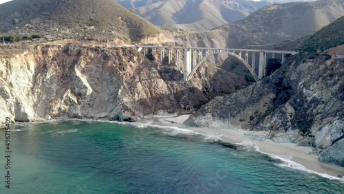 Aerial of the rugged coastline of Big Sur California. The Pacific Coast Highway and the famous Bixby Creek Bridge can be seen.