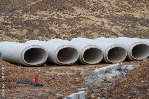 Wallpaper Mural Reinforced concrete storm sewer pipes stacked at a construction site large diameter pipes Torontodigital.ca