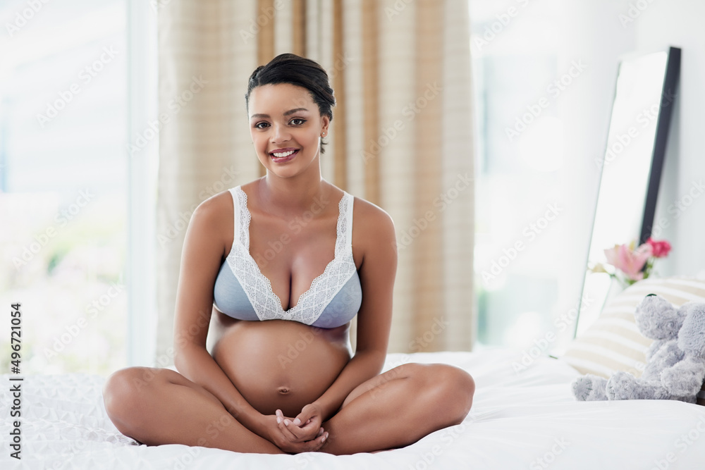 Lifes greatest gift to me has been motherhood. Portrait of a pregnant young woman relaxing on her bed at home. Lifes greatest gift to me has been motherhood. Portrait of a pregnant young woman relaxing on her bed at home.