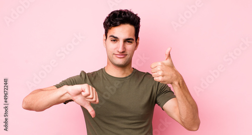 handsome hispanic man feeling confused, clueless and unsure, weighting the good and bad in different options or choices
