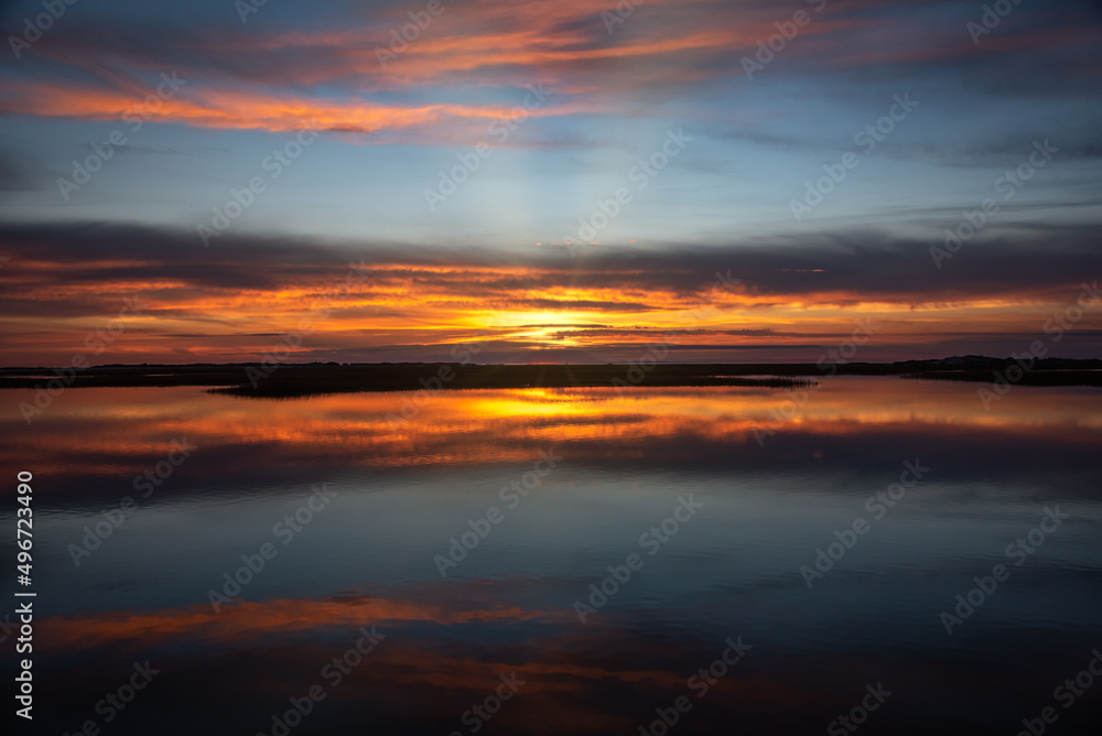 Sunset in Provincetown Causeway in Cape Cod with water reflection of the sky