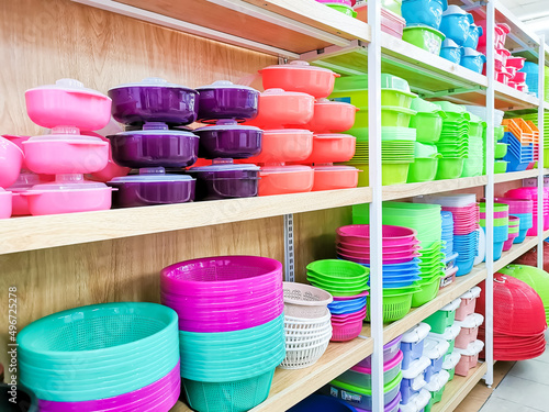 Various type and color plastic household products on supermarker shelf. photo