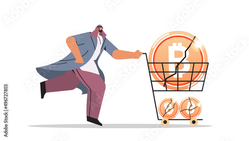 businessman pushing trolley cart with crashed bitcoins cryptocurrency crash price collapse crypto loss investment risk crisis