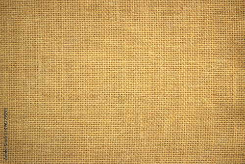 Jute hessian sackcloth burlap canvas woven texture background pattern in light beige cream brown color blank decoration.