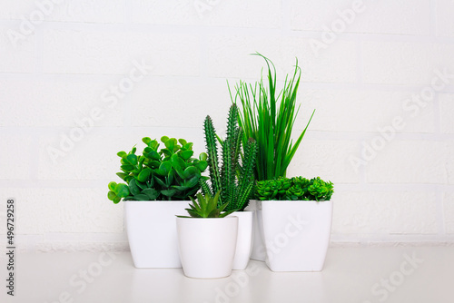 Set artificial flowers, succulents, grass and greenery.