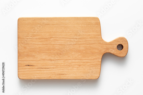 Cherry wood handmade wooden cutting board on white tabletop. Cherry wood texture. wooden board isolated on white