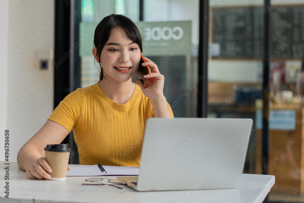 Asian businesswoman working with smartphone and laptop in office Internet technology communication concept Asian businesswoman working with smartphone and laptop in office Internet technology communication concept