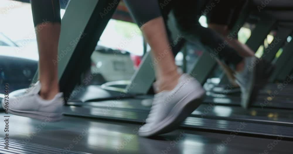Close up legs and foot of group of athletic young people running on machine treadmills during cardio workout exercise in fitness gym club, Sport health lifestyle concept Close up legs and foot of group of athletic young people running on machine treadmills during cardio workout exercise in fitness gym club, Sport health lifestyle concept