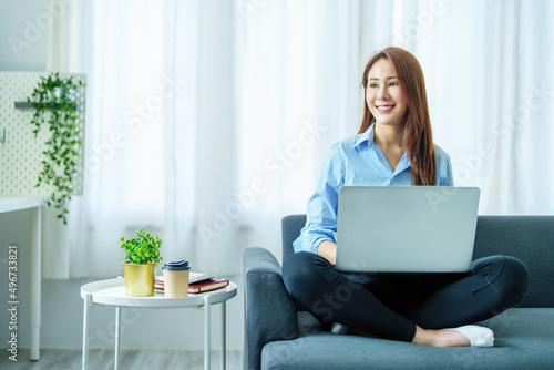 internet learning, online shopping, selling, meeting, information searching, Portrait of young Asian woman showing smiling face while using tablet to work at home.