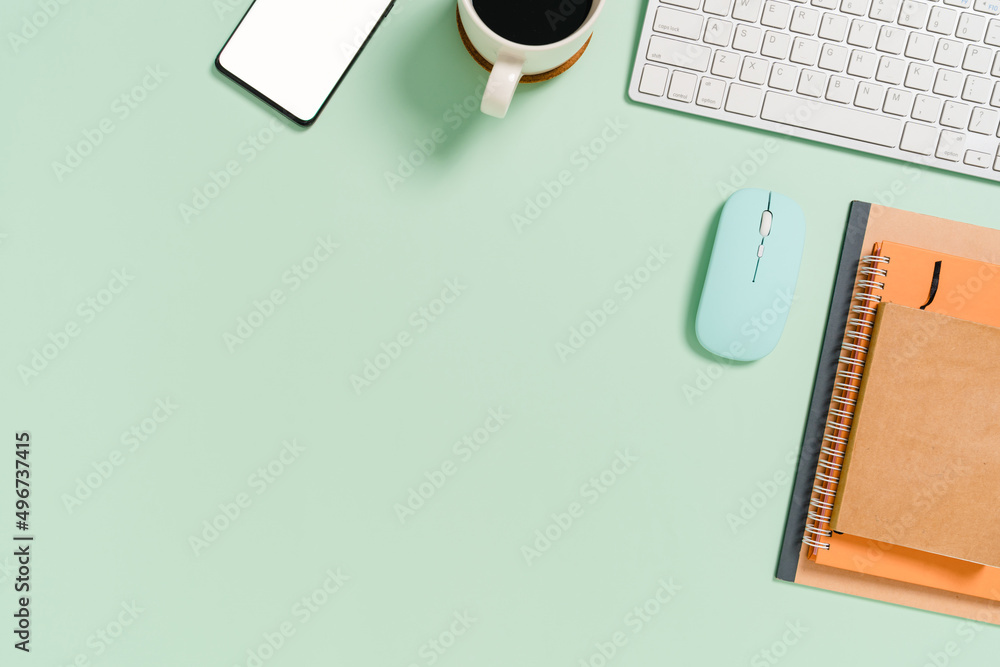 Minimal work space - Creative flat lay photo of workspace desk. Top view office desk with keyboard, mouse and notebook on pastel green color background. Top view with copy space, flat lay photography. Minimal work space - Creative flat lay photo of workspace desk. Top view office desk with keyboard, mouse and notebook on pastel green color background. Top view with copy space, flat lay photography.
