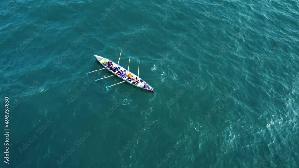 a solo rowing boat, rowing out at sea, off the coast of the UK, on a