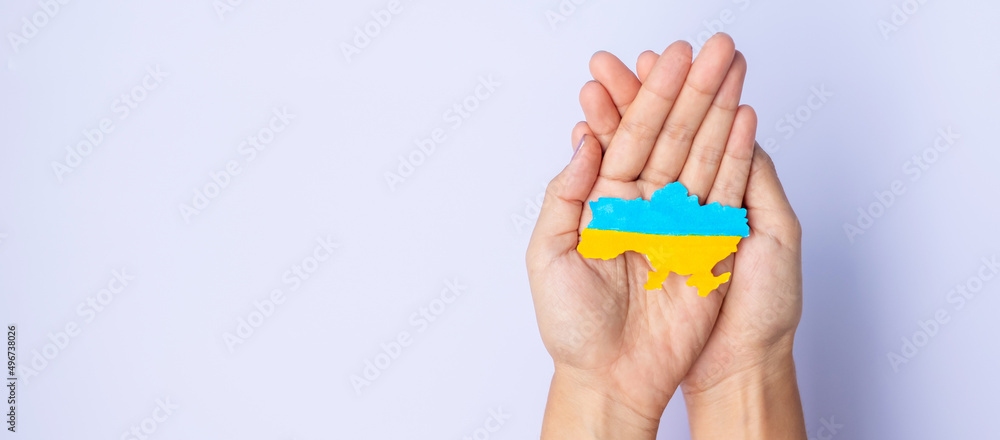 Support for Ukraine in the war with Russia, Hands holding the shape of Ukraine border with color flag. Pray, No war, stop war and stand with Ukraine Support for Ukraine in the war with Russia, Hands holding the shape of Ukraine border with color flag. Pray, No war, stop war and stand with Ukraine