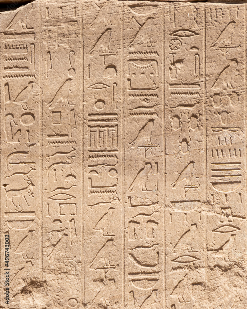 Ancient Egyptian hieroglyphs on the stone walls of the Karnak Temple in Luxor, Egypt Ancient Egyptian hieroglyphs on the stone walls of the Karnak Temple in Luxor, Egypt