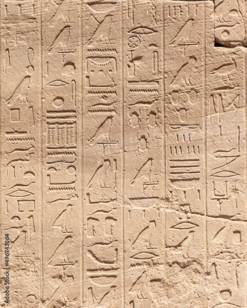 Ancient Egyptian hieroglyphs on the stone walls of the Karnak Temple in Luxor, Egypt Ancient Egyptian hieroglyphs on the stone walls of the Karnak Temple in Luxor, Egypt