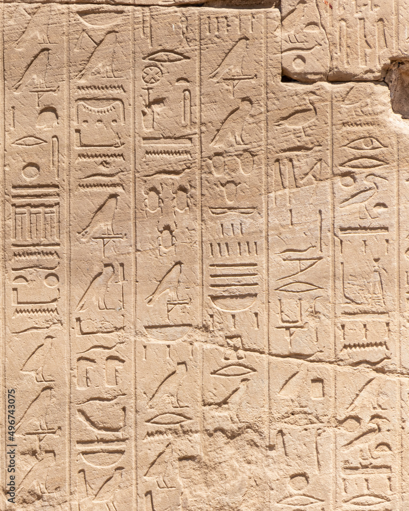 Ancient Egyptian hieroglyphs on the stone walls of the Karnak Temple in Luxor, Egypt Ancient Egyptian hieroglyphs on the stone walls of the Karnak Temple in Luxor, Egypt