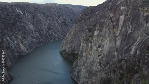 Sheer granite cliffs drop to Salto de Aldeadavila reservoir in Spain photo